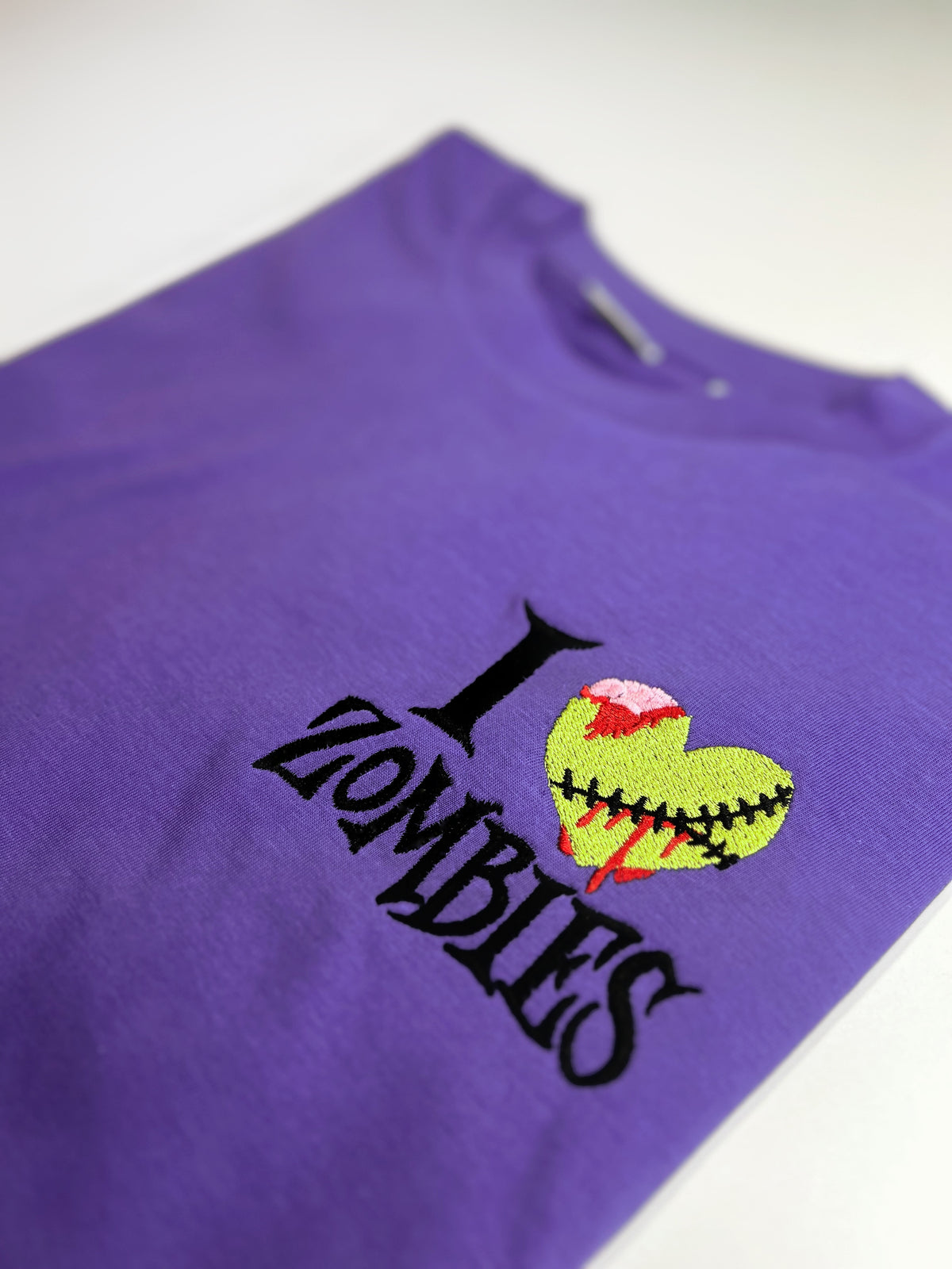 Purple shirt with I Heart Zombies embroidery and a green zombie heart