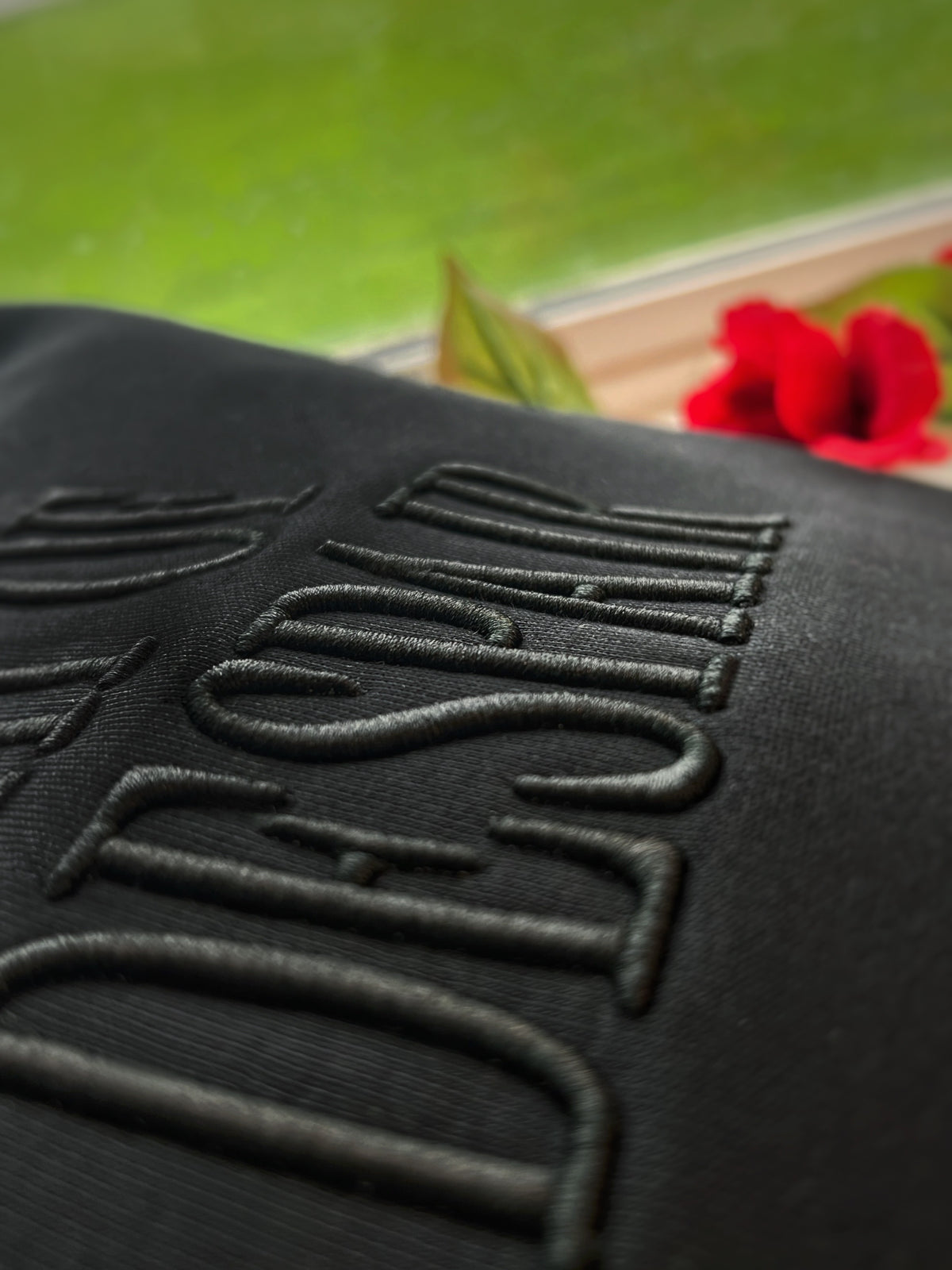Close-up of raised tonal Fresh Despair lettering