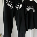Black matching sweatshirt and joggers with skeleton hands embroidery