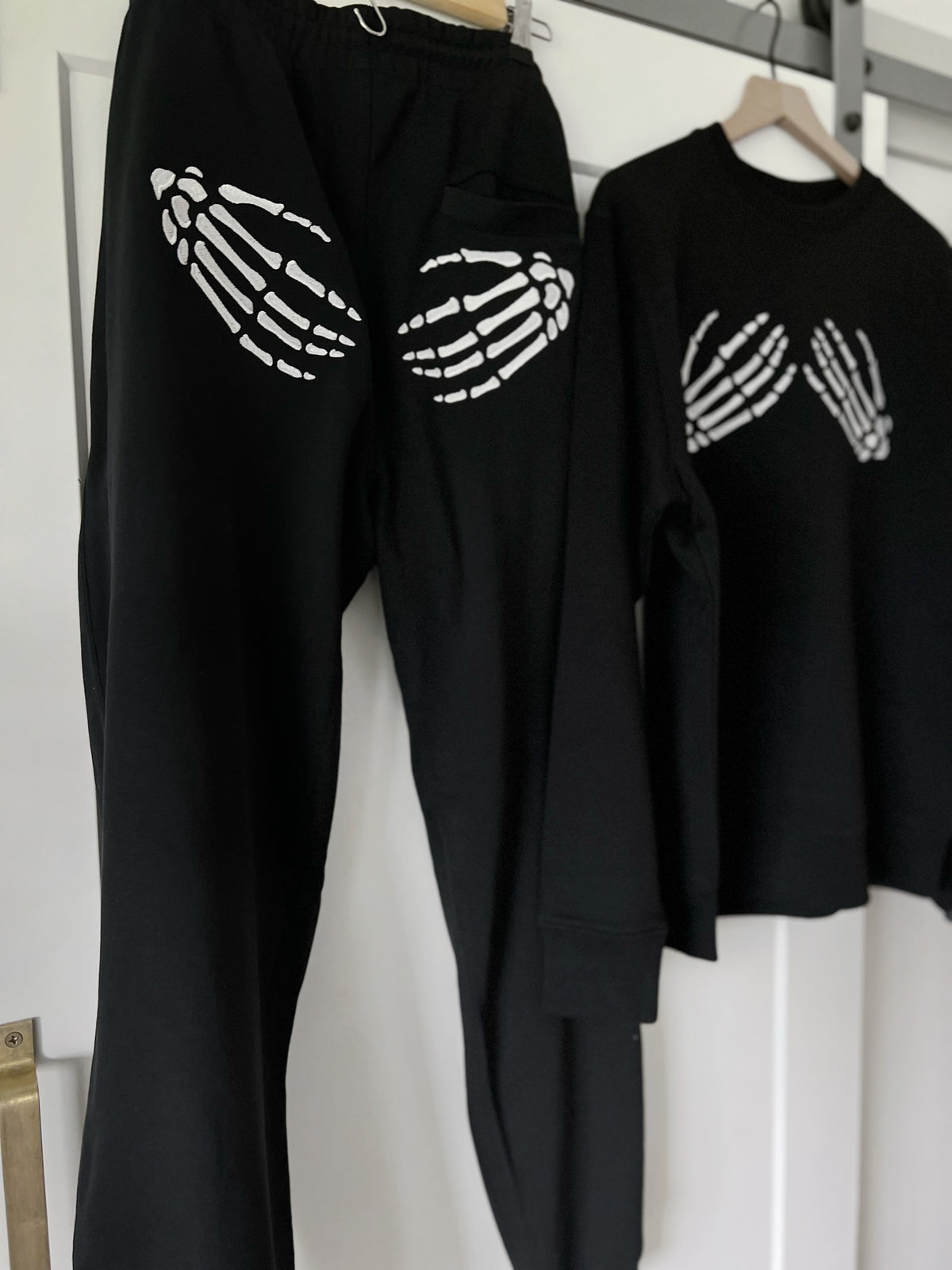 Black matching sweatshirt and joggers with skeleton hands embroidery