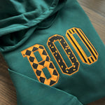 Green hoodie with orange-and-black patterned BOO appliqué
