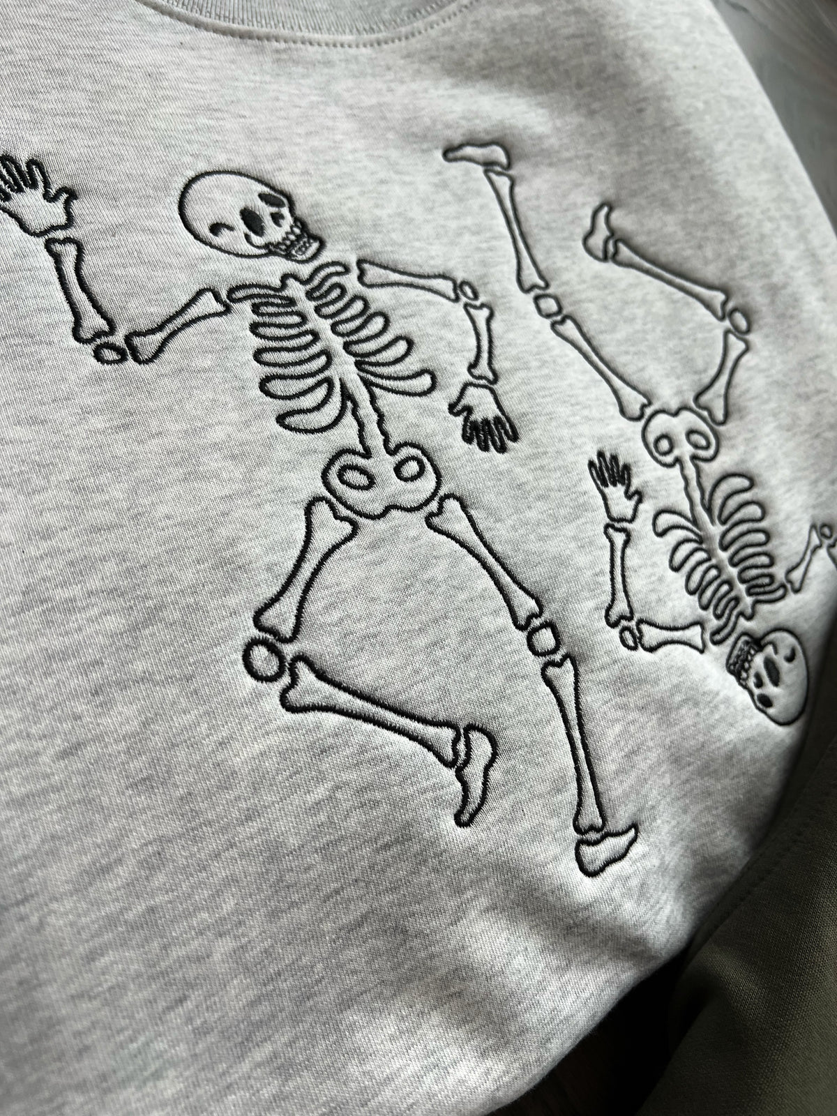 Close-up of dark skeleton stitching on gray fabric