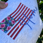 Close-up of red stripes and flowers on gray fabric