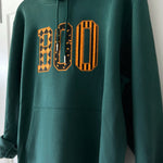 Green BOO appliqué hoodie on a hanger