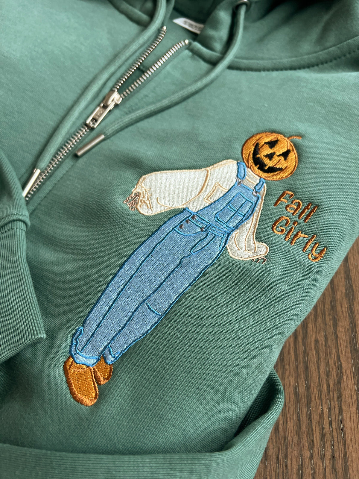 Close-up of scarecrow in blue overalls holding a drink