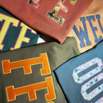 Assorted custom letter sweatshirts in multiple fabrics
