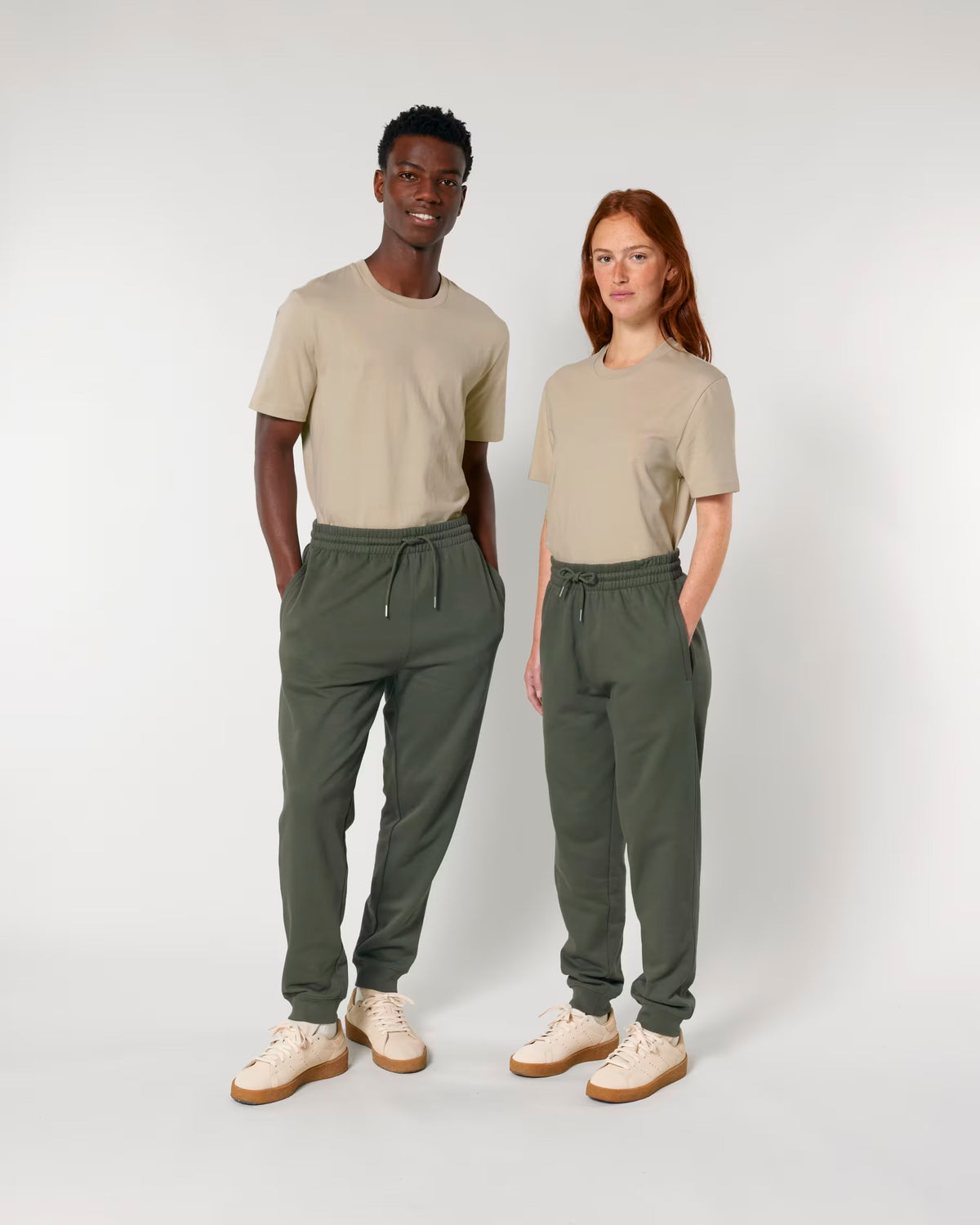Two models wearing plain olive joggers to show fit