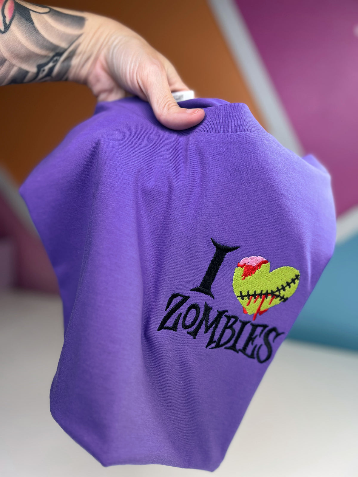Purple I Heart Zombies shirt held up