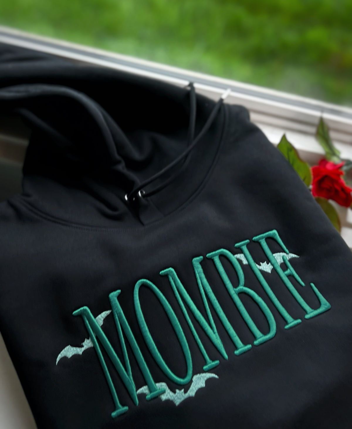 Black hoodie with green MOMBIE puff embroidery and bats
