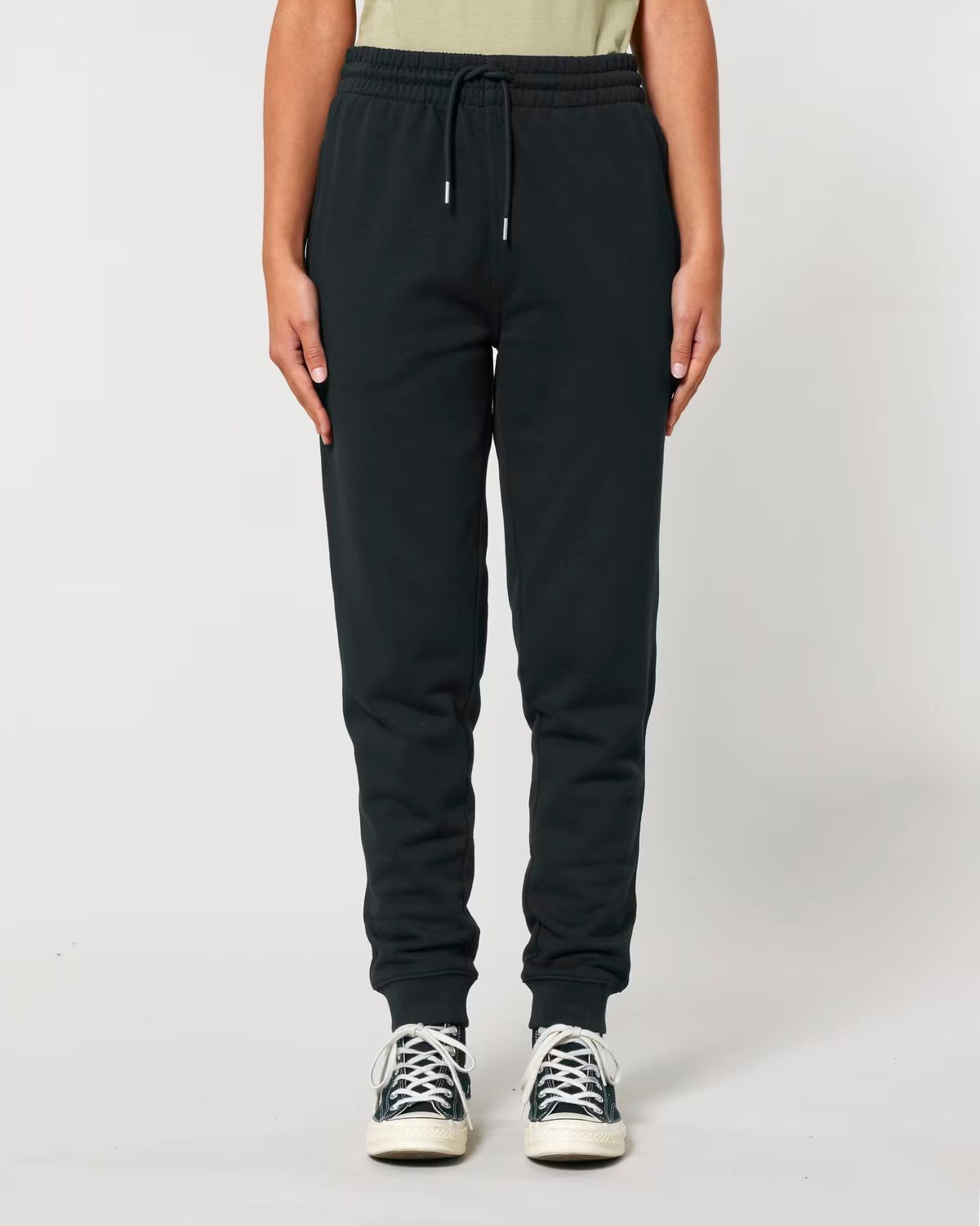 Front view of plain black joggers on a model